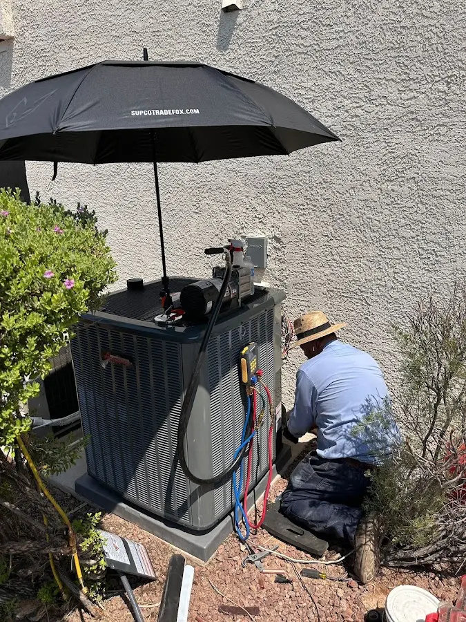 HVAC technician performing outdoor AC maintenance in Pinecrest
